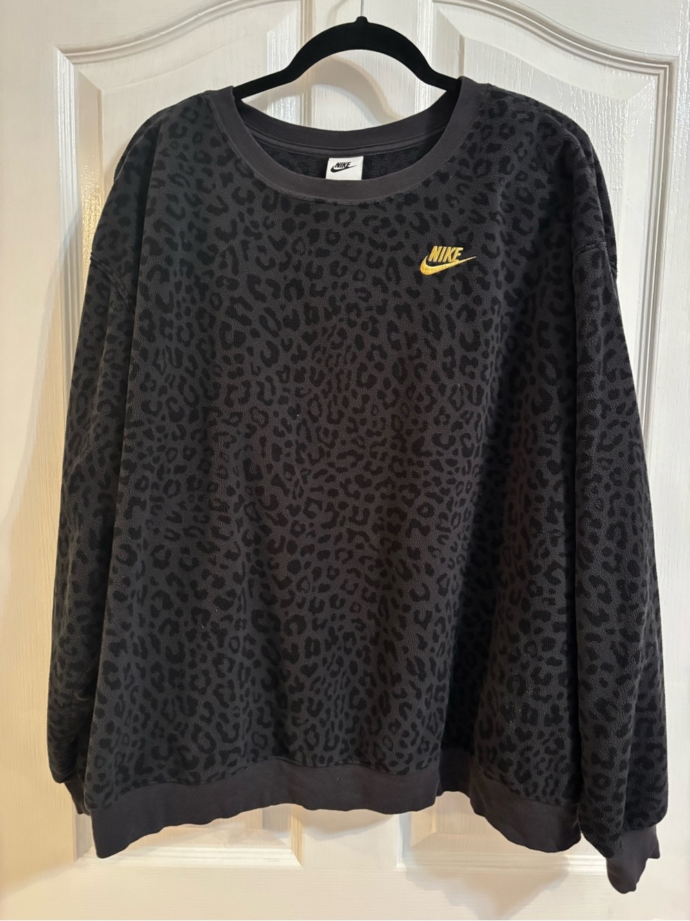 Nike Women's Black Crewneck Sweater with Gold Swoosh